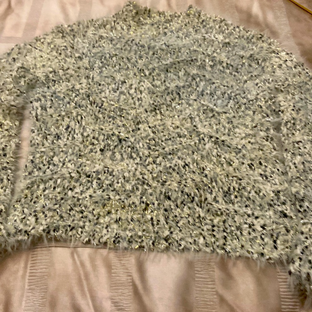 Loose stretchy silver threads through out. Soft and lightweight.